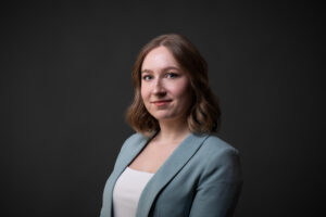 Professional corporate headshot of a Calgary businesswoman wearing a baby blue blazer