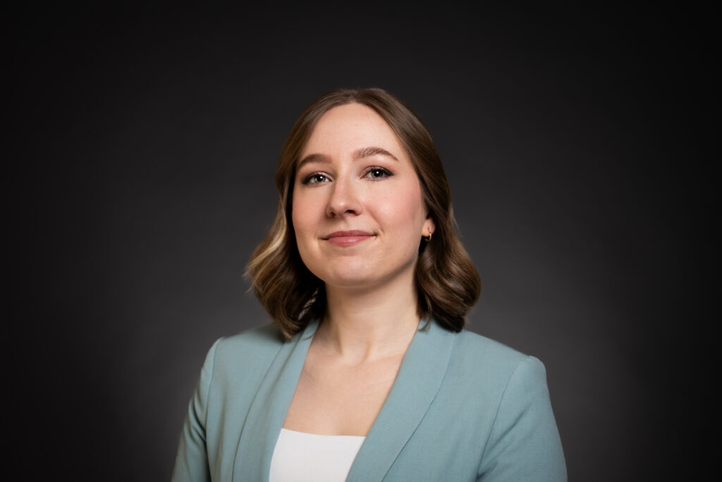 Professional corporate headshot of a Calgary businesswoman wearing a baby blue blazer