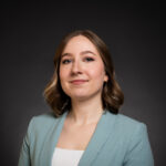 Professional corporate headshot of a Calgary businesswoman wearing a baby blue blazer