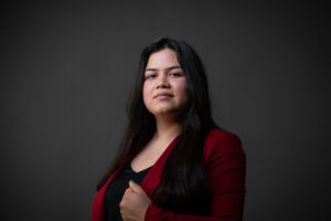 Professional corporate headshot of a Calgary businesswoman wearing a cherry red blazer